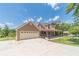 Lovely exterior featuring a three-car garage, covered porch, fenced yard, complemented by a concrete driveway at 3040 Sandy Creek Ct, Loganville, GA 30052
