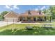 Beautiful exterior featuring a large porch, and manicured lawn, complemented by a detached garage and landscaping at 3040 Sandy Creek Ct, Loganville, GA 30052