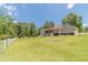 Side of the house with a large, grassy yard and white fence; ideal for outdoor activities and privacy at 3040 Sandy Creek Ct, Loganville, GA 30052
