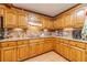 Charming kitchen design with wood cabinets, granite countertops, and tiled backsplash at 3040 Sandy Creek Ct, Loganville, GA 30052