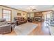 Comfortable living room features hardwood floors, brick fireplace, and ample space for entertaining guests at 3040 Sandy Creek Ct, Loganville, GA 30052