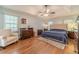 Spacious main bedroom with a tray ceiling, hardwood floors, and ample natural light creates a cozy atmosphere at 3040 Sandy Creek Ct, Loganville, GA 30052