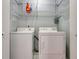 Functional laundry room with washer, dryer, and overhead shelving at 3310 Bryan Way, Marietta, GA 30008