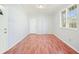 Living room featuring hardwood floors, two windows, and an exterior door at 3310 Bryan Way, Marietta, GA 30008