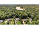 Aerial view of property surrounded by lush greenery and mature trees, plus lake in the distance at 4119 Alayna Lee Cir, Mcdonough, GA 30252