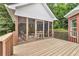 Covered and screened back porch with outdoor furniture set on wood deck with railing at 4119 Alayna Lee Cir, Mcdonough, GA 30252