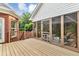 Back porch with wooden deck and screened-in outdoor living space with seating and a table at 4119 Alayna Lee Cir, Mcdonough, GA 30252
