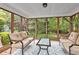 Screened-in porch with an outdoor seating area offering wooded views and natural light at 4119 Alayna Lee Cir, Mcdonough, GA 30252