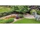 Overhead view of the backyard featuring a picturesque pond, swing, stone firepit and manicured lawn at 4119 Alayna Lee Cir, Mcdonough, GA 30252