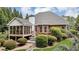 Exterior view of patio with table and chairs, screened in porch and beautifully landscaped yard at 4119 Alayna Lee Cir, Mcdonough, GA 30252