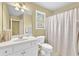 Bright bathroom featuring a large mirror, white vanity, and shower with curtain at 4119 Alayna Lee Cir, Mcdonough, GA 30252