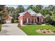 View of the property featuring two-story brick home, detached garage, and a well-manicured lawn at 4119 Alayna Lee Cir, Mcdonough, GA 30252