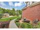 Landscaped walkway leading to a brick home with a view of a lush green lawn and neighboring house at 4119 Alayna Lee Cir, Mcdonough, GA 30252