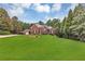Charming two-story brick home featuring lush green lawn, manicured landscaping, and attached two-car garage at 4119 Alayna Lee Cir, Mcdonough, GA 30252