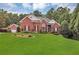 Charming two-story brick home featuring lush green lawn, manicured landscaping, and attached two-car garage at 4119 Alayna Lee Cir, Mcdonough, GA 30252