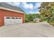 Spacious driveway featuring three-car garage with carriage style doors and additional detached garage at 4119 Alayna Lee Cir, Mcdonough, GA 30252