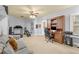 Home gym area with carpet flooring, office area, door to outside, sofa, ceiling fan, and exercise equipment at 4119 Alayna Lee Cir, Mcdonough, GA 30252