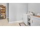 Functional laundry room with washer, dryer, and storage shelving, perfect for organization at 4119 Alayna Lee Cir, Mcdonough, GA 30252