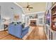 Comfortable living room with vaulted ceiling, fireplace, wood floors, and a plush blue sofa at 4119 Alayna Lee Cir, Mcdonough, GA 30252