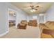 Spacious living room with neutral walls, cozy seating and access to game room at 4119 Alayna Lee Cir, Mcdonough, GA 30252