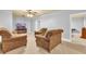 Inviting living room featuring plush armchairs, neutral walls, and cozy carpeting at 4119 Alayna Lee Cir, Mcdonough, GA 30252