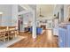Open-concept living room featuring hardwood floors, high ceilings, and a cozy fireplace at 4119 Alayna Lee Cir, Mcdonough, GA 30252