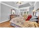 Bright main bedroom featuring hardwood floors, tray ceiling, and sitting area at 4119 Alayna Lee Cir, Mcdonough, GA 30252