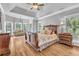 Spacious main bedroom with tray ceilings, hardwood floors, and ample natural light at 4119 Alayna Lee Cir, Mcdonough, GA 30252