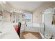 Bright bathroom features a soaking tub with tile surround and a separate glass shower at 6597 River Island Drive Dr, Buford, GA 30518