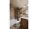 Elegant bathroom featuring a tub/shower combo and a vanity with an ornate mirror at 6597 River Island Drive Dr, Buford, GA 30518