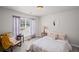 Bright bedroom with neutral tones, complemented by a large window for natural light at 6597 River Island Drive Dr, Buford, GA 30518
