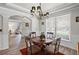 Elegant dining room with decorative lighting, wainscoting, and stylish furnishings at 6597 River Island Drive Dr, Buford, GA 30518