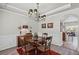 Elegant dining room with decorative lighting, wainscoting, and stylish furnishings at 6597 River Island Drive Dr, Buford, GA 30518