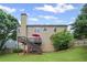 Back of house featuring large deck, stairs, and a spacious lawn at 6597 River Island Drive Dr, Buford, GA 30518