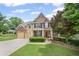 Charming two-story home boasts a manicured lawn, brick accents, and inviting front porch at 6597 River Island Drive Dr, Buford, GA 30518