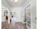 Inviting foyer with hardwood floors, white wainscoting, and elegant architectural details at 6597 River Island Drive Dr, Buford, GA 30518