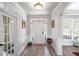 Bright foyer featuring hardwood floors, natural light, and elegant white trim at 6597 River Island Drive Dr, Buford, GA 30518