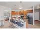 Bright eat-in kitchen featuring wood cabinets, stainless steel appliances, and a center island with seating at 6597 River Island Drive Dr, Buford, GA 30518