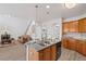 Modern kitchen boasts granite counters, stainless appliances, island seating and seamless flow to the living areas at 6597 River Island Drive Dr, Buford, GA 30518