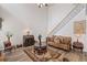 Spacious living room view boasts a staircase and is bathed in natural light, creating an inviting atmosphere at 6597 River Island Drive Dr, Buford, GA 30518