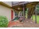 Back of house featuring a covered patio, stairs, and landscaped garden at 6597 River Island Drive Dr, Buford, GA 30518