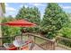 Cozy patio with outdoor seating and an umbrella, surrounded by lush greenery at 6597 River Island Drive Dr, Buford, GA 30518