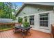 Deck features wood flooring, table and chairs, and a view of the backyard at 1564 Belva Ave, Decatur, GA 30032