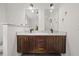 Bright bathroom with dual sinks, dark cabinets and stylish fixtures at 1564 Belva Ave, Decatur, GA 30032