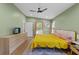 A bright bedroom with hardwood floors, ceiling fan, large window and a dresser at 1564 Belva Ave, Decatur, GA 30032