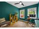 This vibrant bedroom features hardwood floors, bright natural light and a ceiling fan at 1564 Belva Ave, Decatur, GA 30032