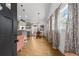 Bright and airy entryway featuring hardwood floors, modern lighting, and an open floor plan to the kitchen at 1564 Belva Ave, Decatur, GA 30032