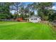 Scenic exterior showcasing a well-manicured lawn, mature trees, and a charming home with a backyard at 1564 Belva Ave, Decatur, GA 30032