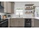 Bright kitchen with stainless steel appliances, floating shelves, subway tile and hardwood floors at 1564 Belva Ave, Decatur, GA 30032