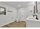 Bright bathroom featuring a dual vanity, modern black fixtures, and wood-look tile floors at 336 Fond Du Lac Dr, Stone Mountain, GA 30088